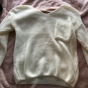 White sweater with pocket and criss costs in back
